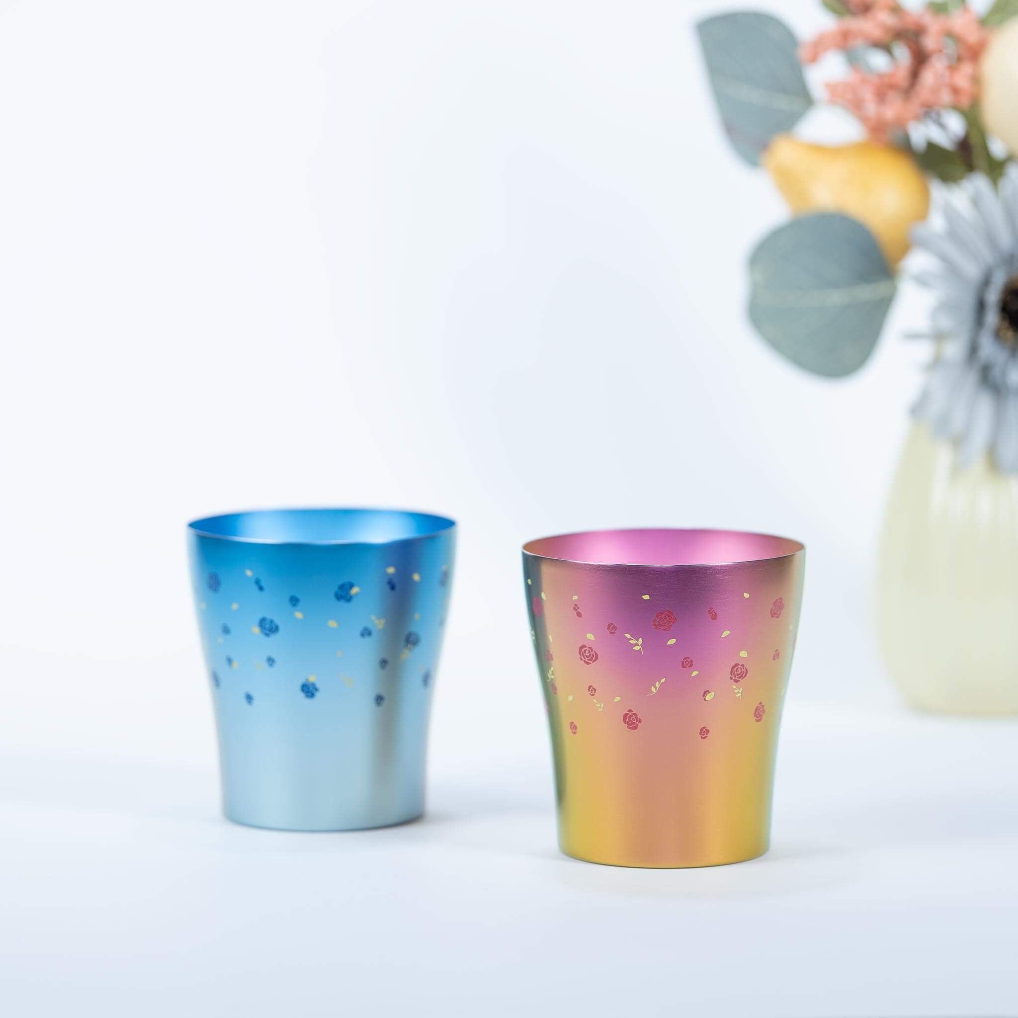 HORIE Hana Series blue and pink titanium tumbler pair in a tabletop setting
