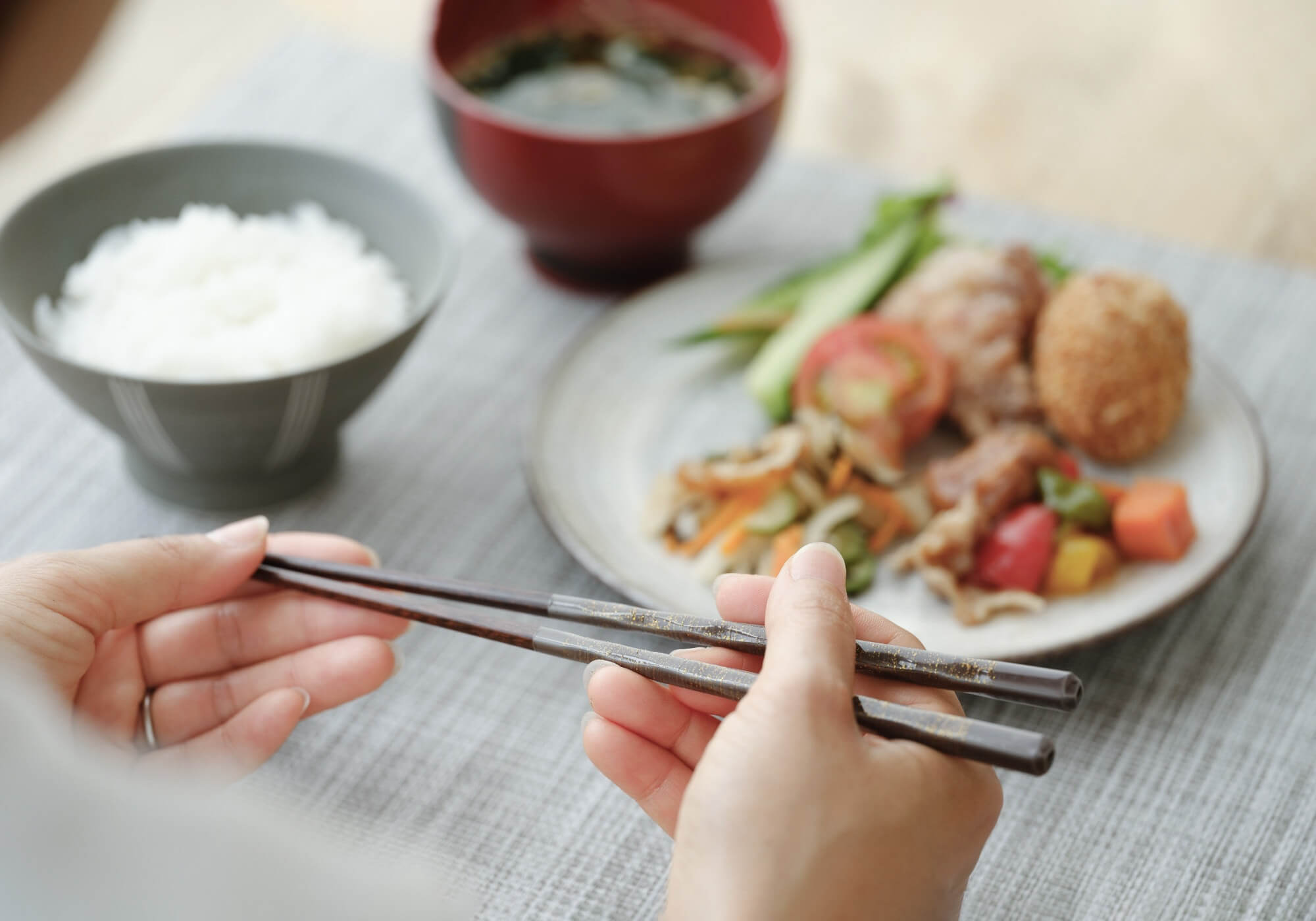 Japanese chopsticks in use during a traditional meal, showcasing elegant Japanese tableware and dining culture.