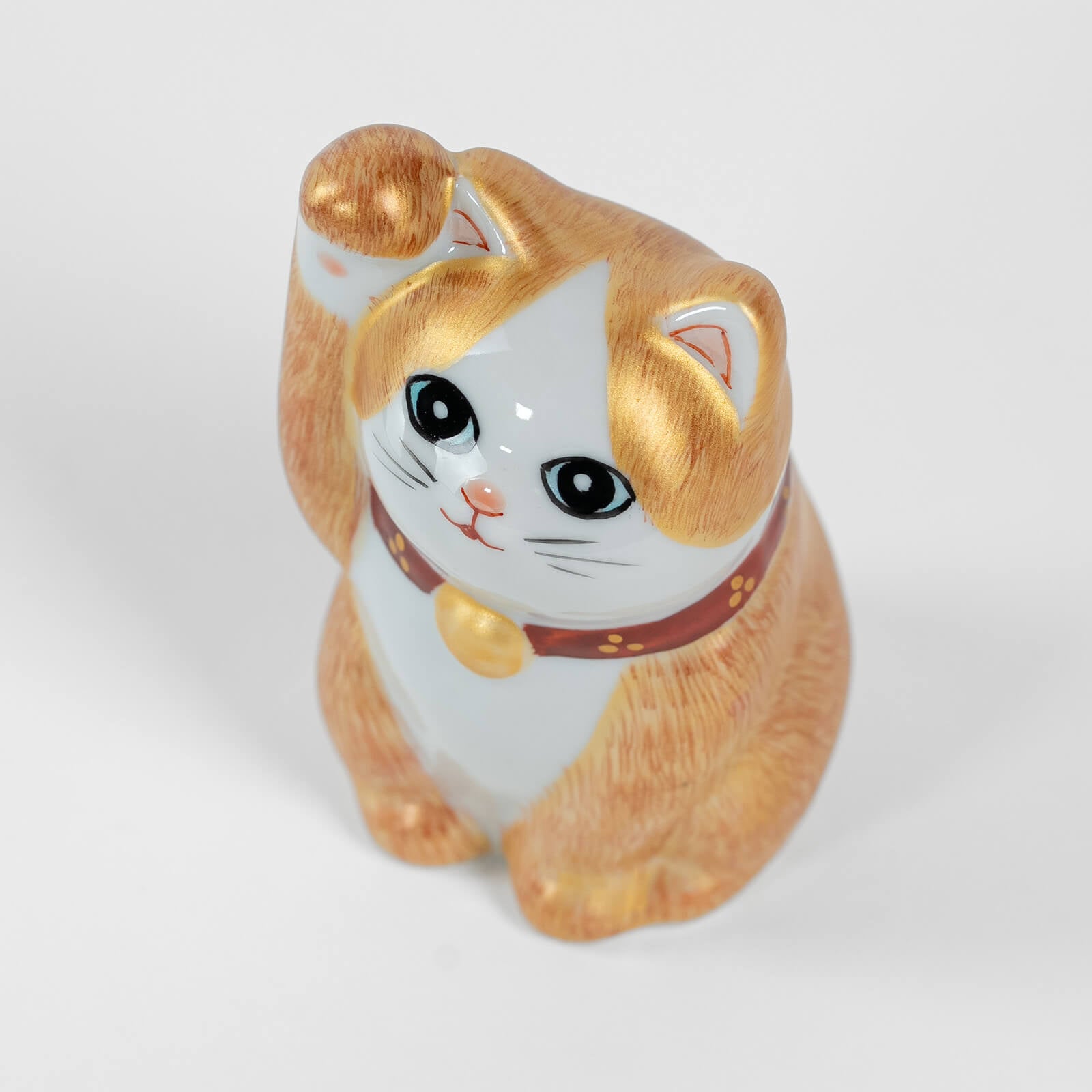 Top view of 10cm Kutani ceramic lucky cat, hand-painted details.