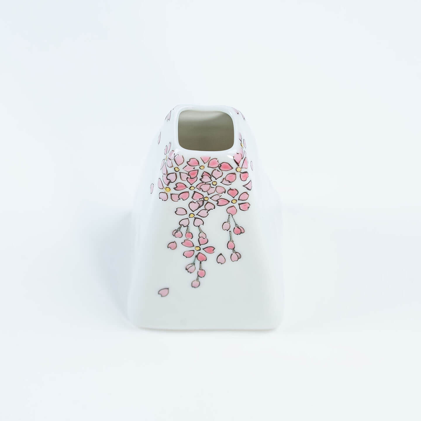 A white Kutani-yaki ceramic vase in the shape of Mt. Fuji with a pink cherry blossom pattern.