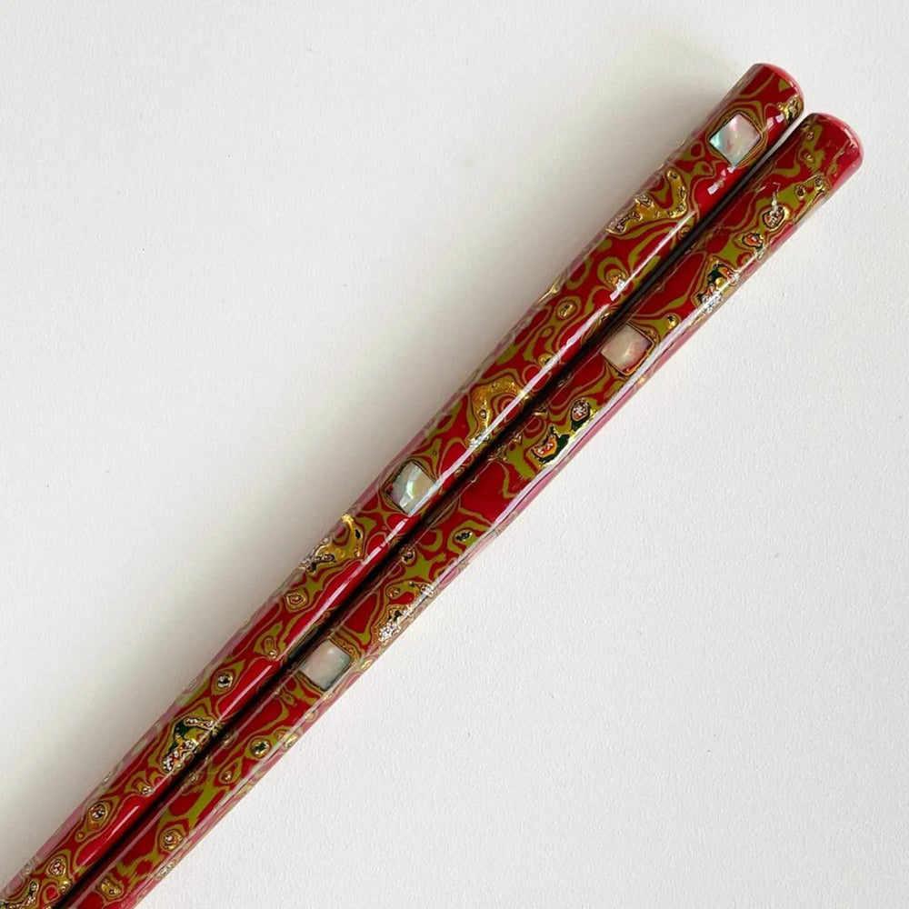 Close-up of shimmering abalone shell inlay on luxurious Japanese chopsticks.