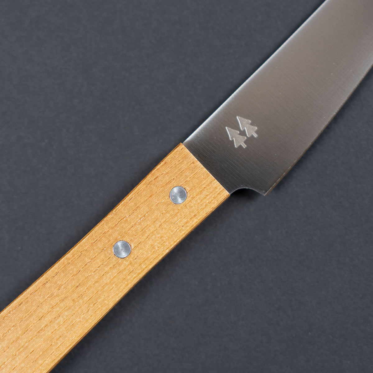 Close-up of the keyaki wood grain and handle rivets on the Shizuhamono Morinoki petty knife