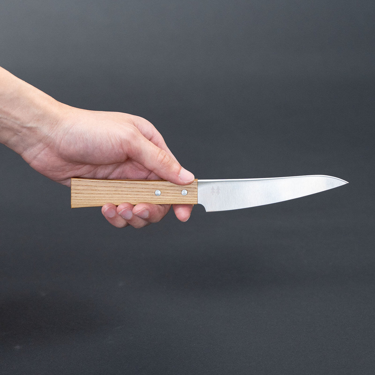 Side view of the Shizuhamono Morinoki 120mm petty knife held in one hand
