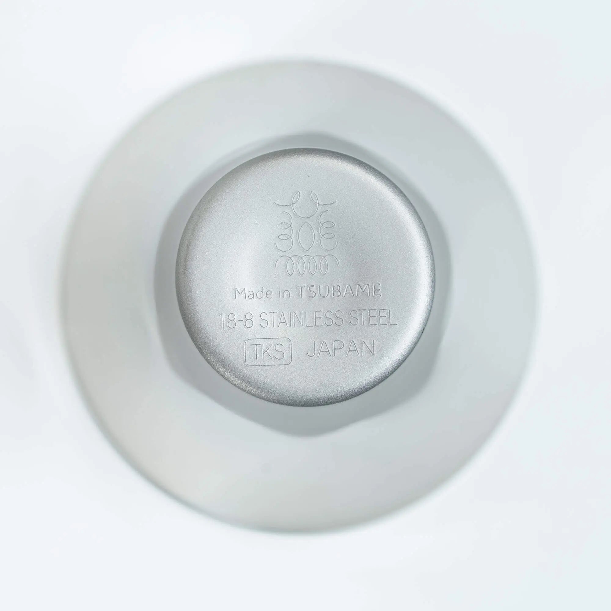 Sake cup bottom with engraved brand logo, stainless steel design