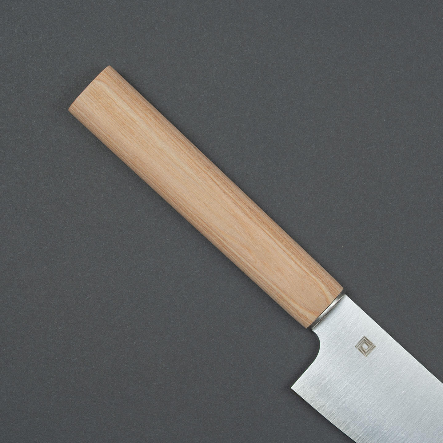 Close-up of the natural wooden handle and bolster of the Shizu Hamono chef knife