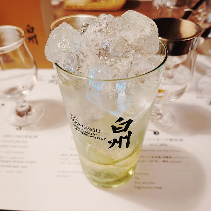 Suntory Hakushu Thin-Walled Tumbler on a table, showing whiskey filled inside