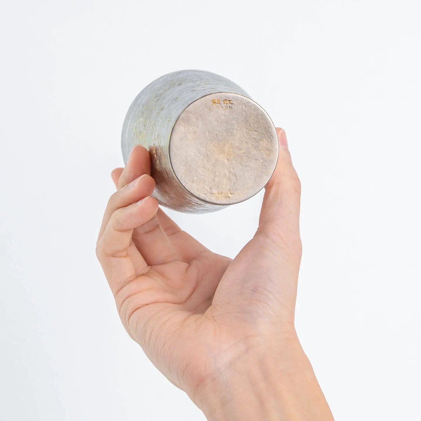 Close-up of the tumbler's bottom, showing the "Taiko" logo and silver texture.
