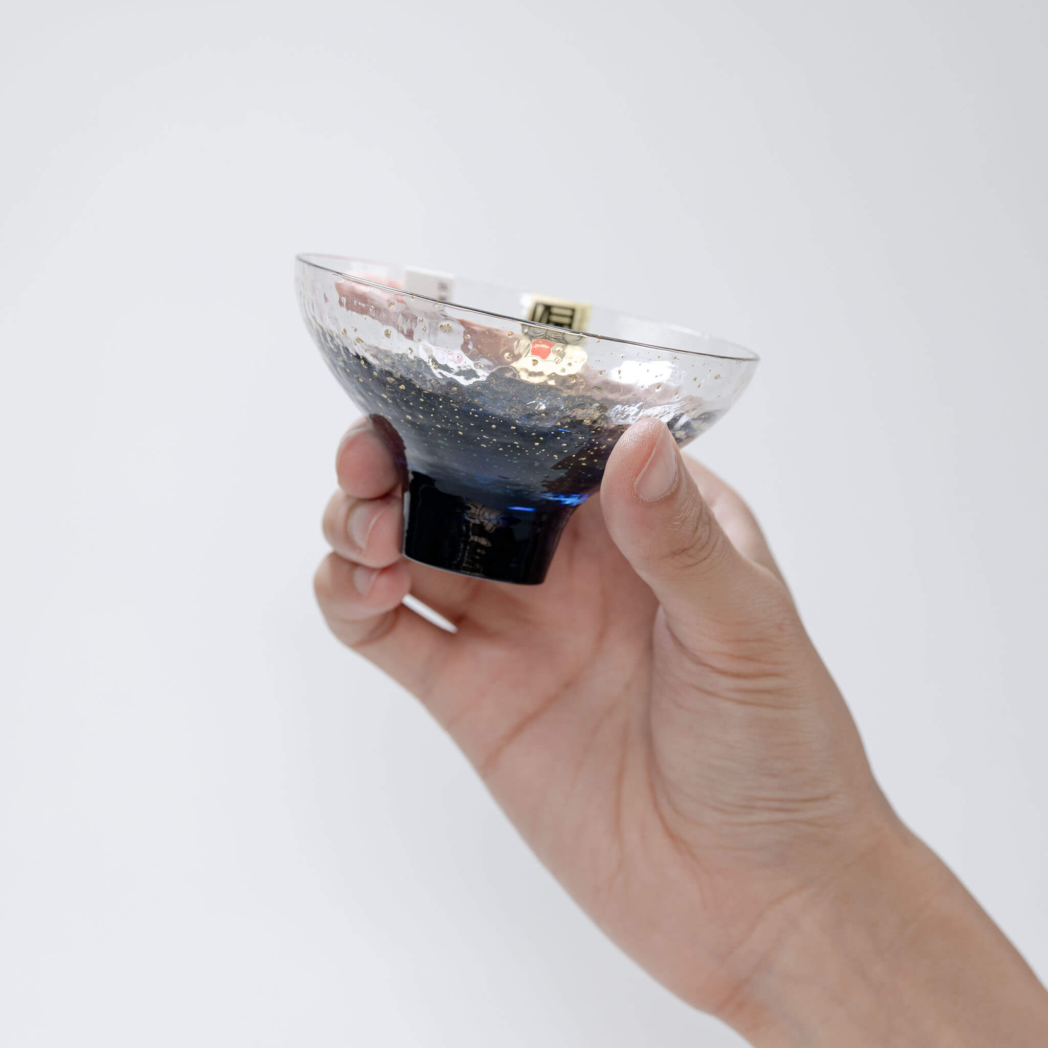 Handheld top view showing the blue interior of the Yachiyo Kiln sake cup