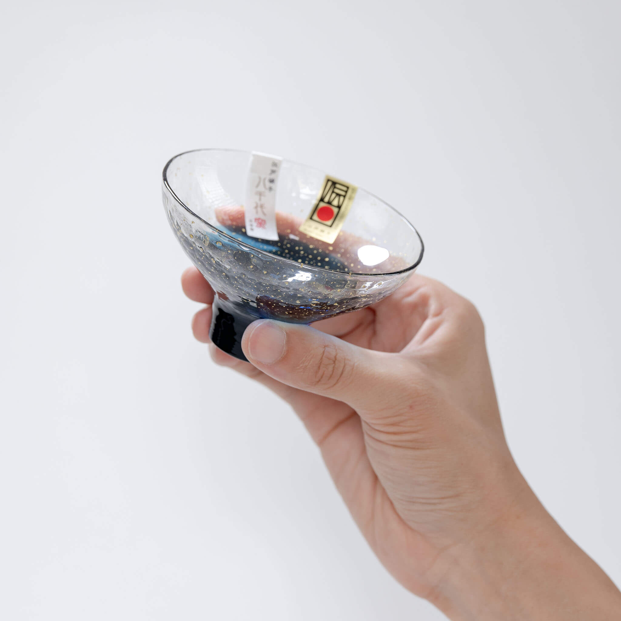Handheld top view showing the blue interior of the Yachiyo Kiln sake cup