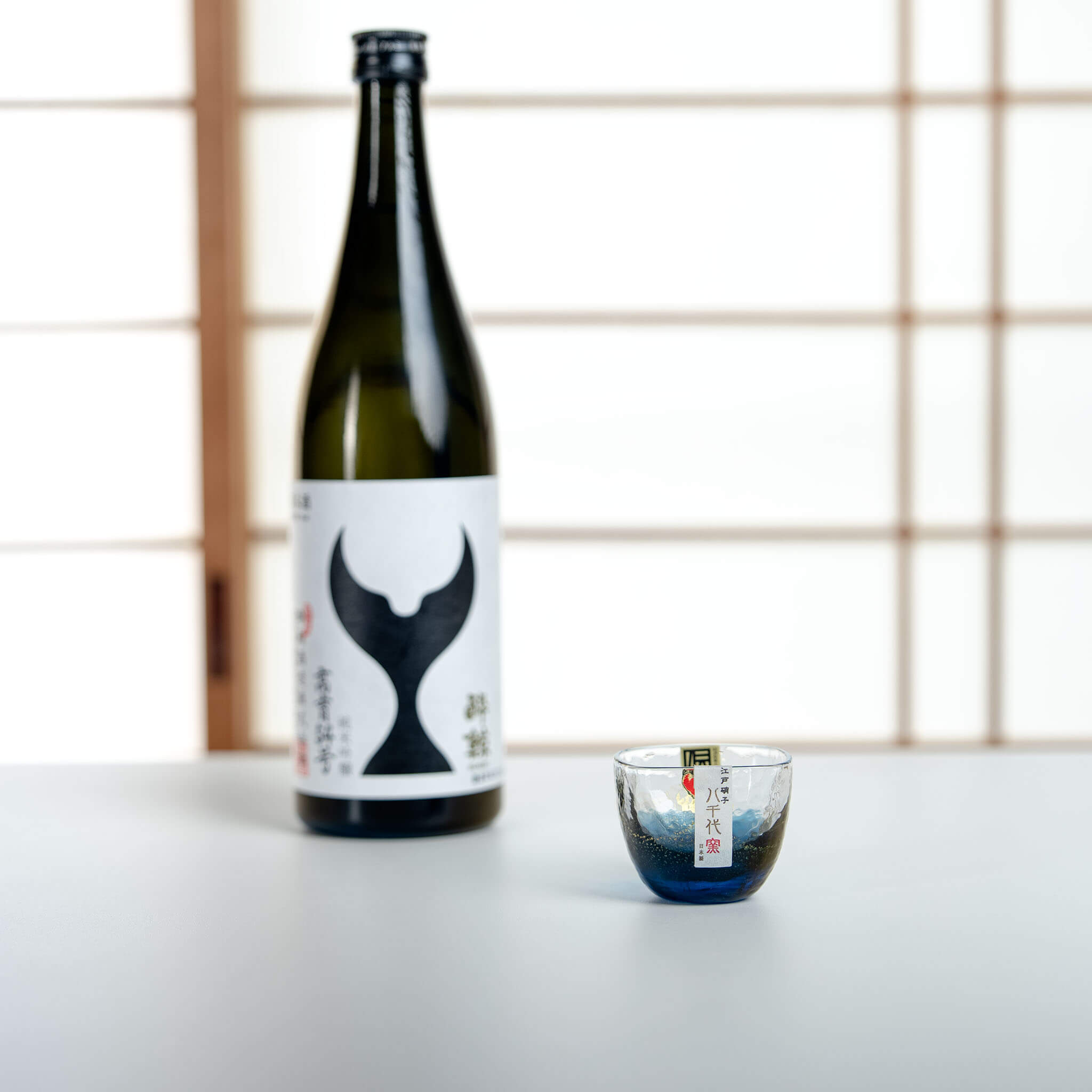 Toyo Sasaki blue glass sake cup in a Japanese sake serving setting