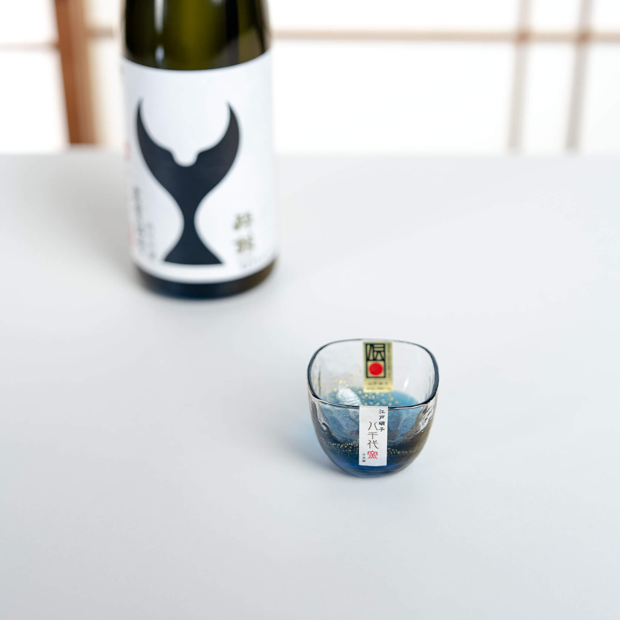Yachiyo Kiln 60ml Edo glass sake cup displayed beside a Japanese sake bottle