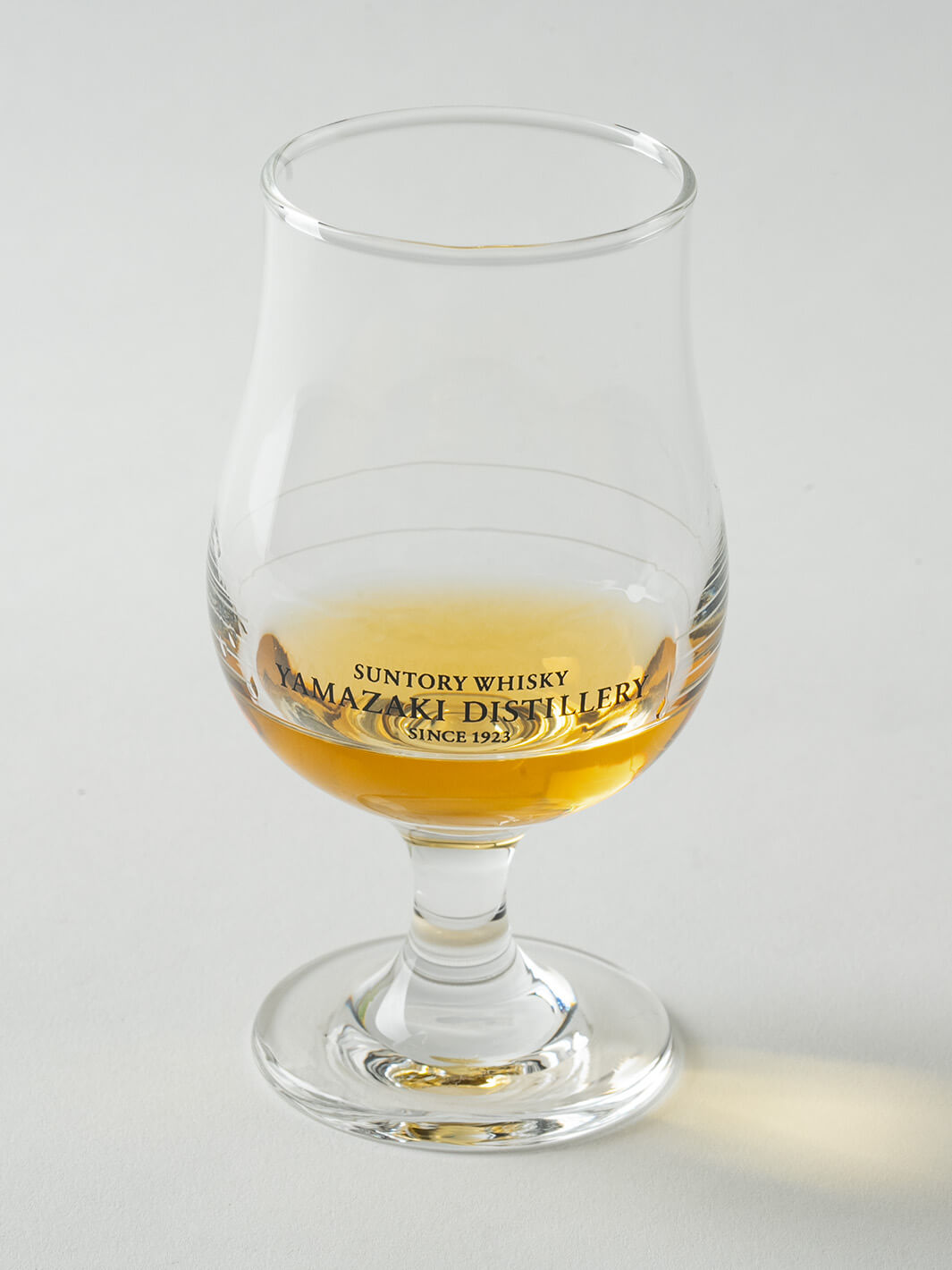 Angled view of Yamazaki whiskey tasting glass with whisky, limited edition